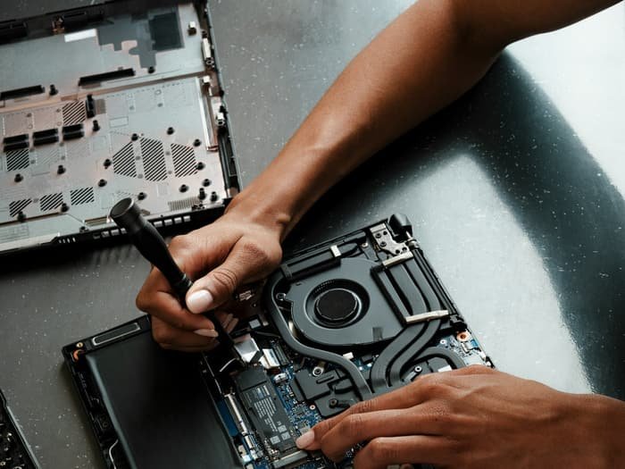 Lappytech technician repairing a laptop's internal components
